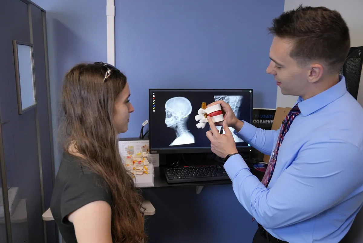 Dr. C.J. Levand reviewing x-rays with a patient