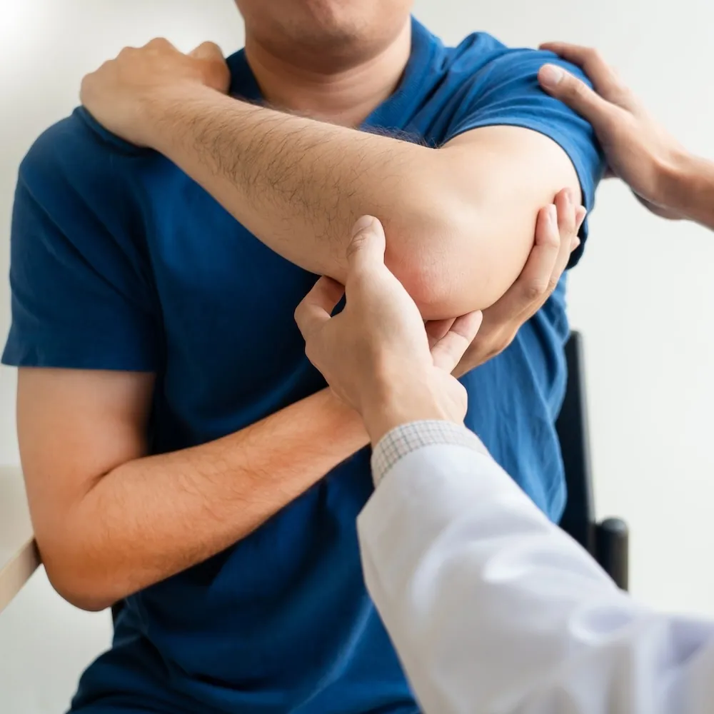 Chiropractor examining a patient’s shoulder