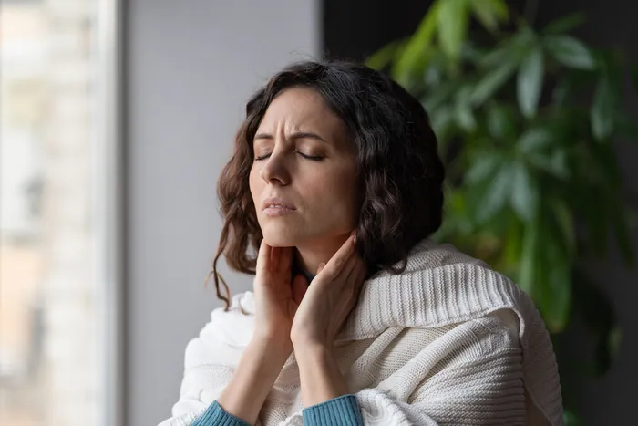 Woman rubbing a stiff neck
