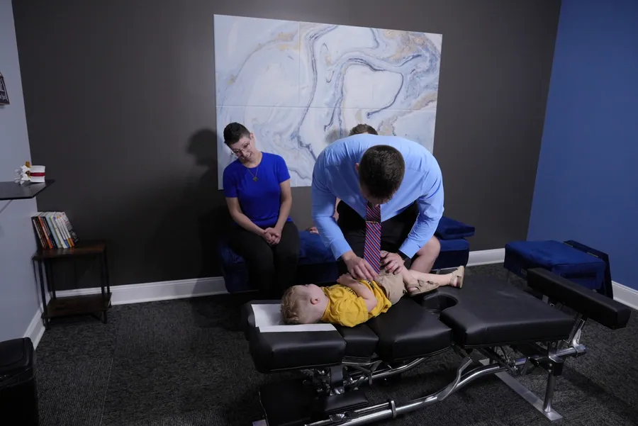 Dr. C.J. Levand gently adjusting a child