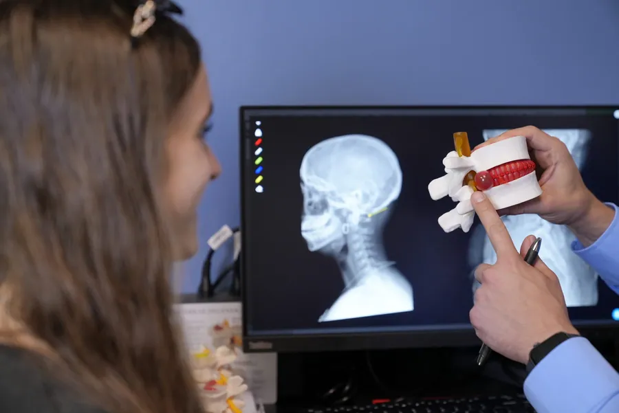 Reviewing a neck x-ray with a spine model