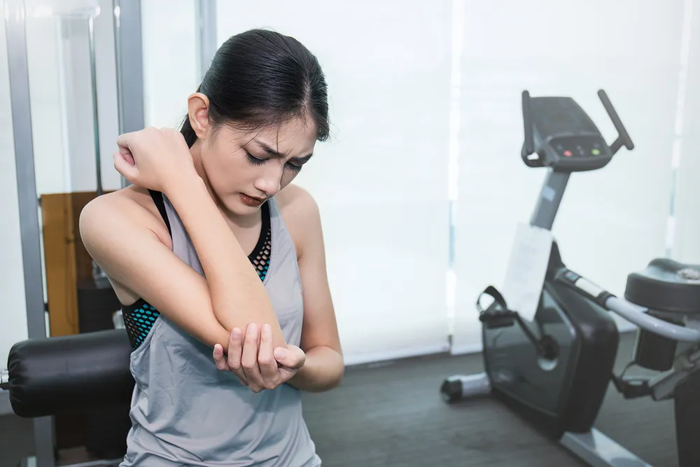 Chiropractor evaluating wrist and hand pain during an examination