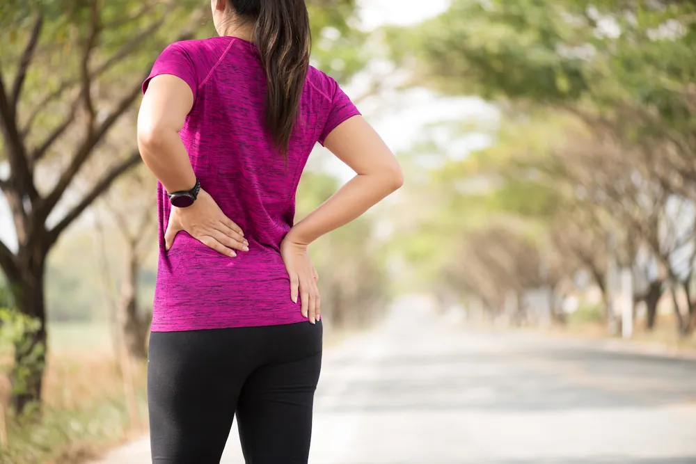 Active woman with lower back discomfort benefiting from chiropractic treatment