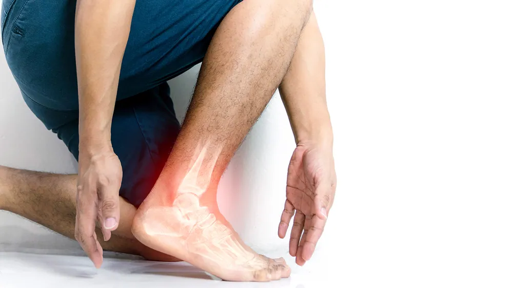Person with ankle pain and inflammation receiving chiropractic treatment