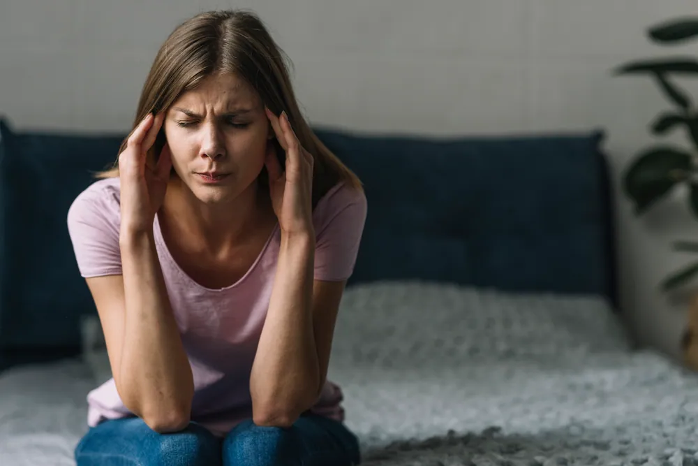 Woman experiencing severe migraine symptoms before chiropractic treatment