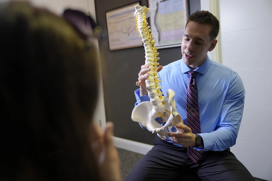 Dr. C.J. Levand explaining the spine with a spine model