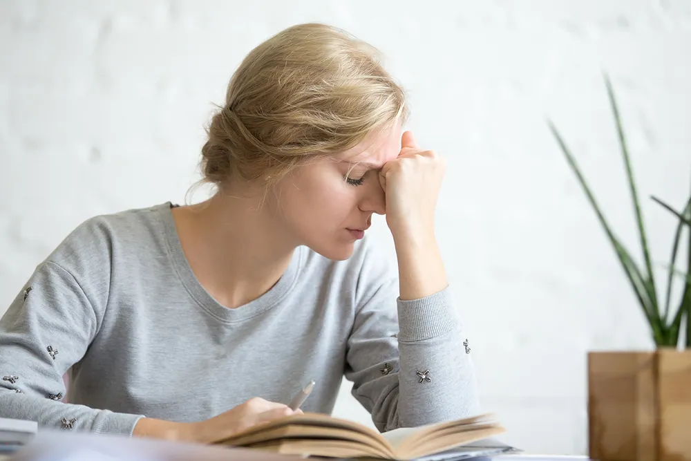 Woman feeling lightheaded and unsteady due to vertigo before receiving chiropractic treatment to improve balance