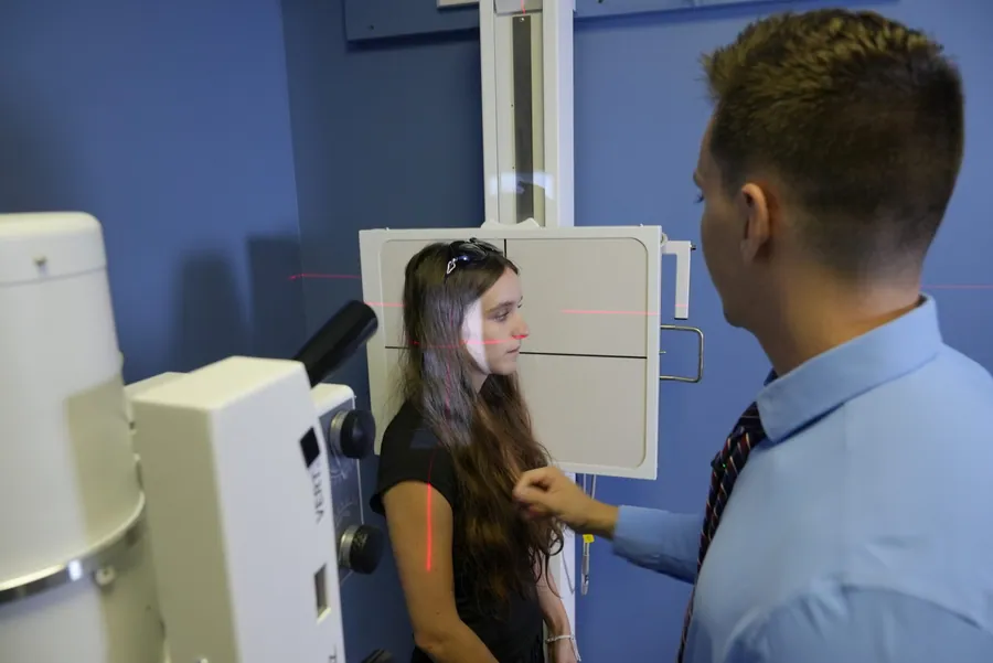 Dr. C.J. Levand with a patient in the x-ray room